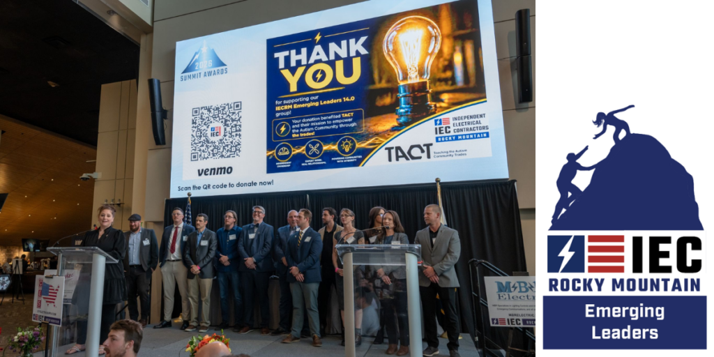 Group of speakers and attendees on a stage at a conference, large screen behind them with 'THANK YOU' message and light bulb graphic, IEC Rocky Mountain Emerging Leaders banner on the side panel